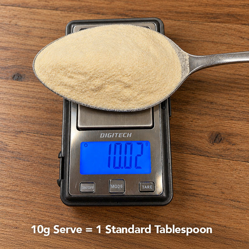 Collagen powder on a spoon with measuring scales