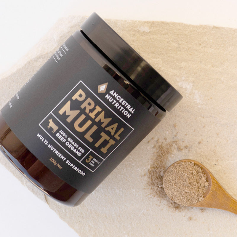 Primal Multi beef organ supplement jar with a wooden spoonful of powder on a light background