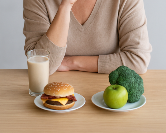 women contemplating whether to eat a burger or vegetables