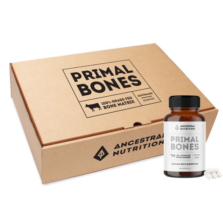 Primal Bones supplement bottle in front of a cardboard box with the brand logo.
